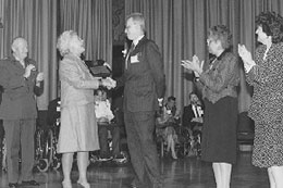 George Burk receiving award from Barbara Bush